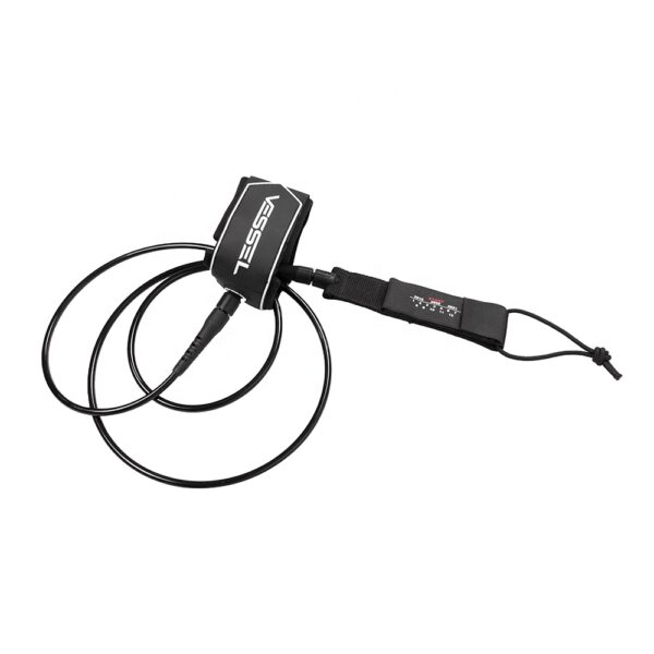 This image shows another side - view of the black Vessel ankle leash. The perspective is slightly different from the first two pictures, but the features like the coiled design, Velcro strap, and the brand name "VESSEL" remain consistent.