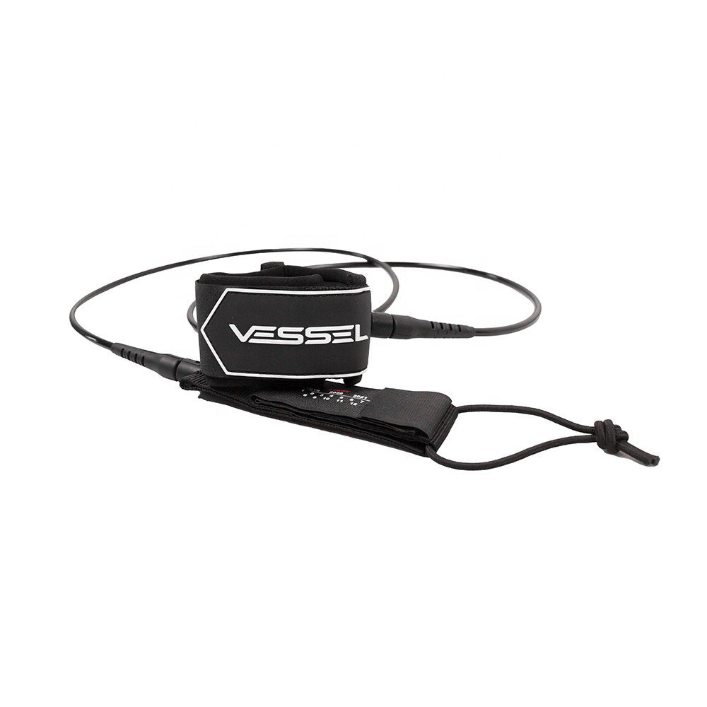 This image shows a slightly angled side - view of the black Vessel ankle leash. The features such as the coiled design, Velcro strap, and the brand name "VESSEL" are clearly visible, similar to the first picture.