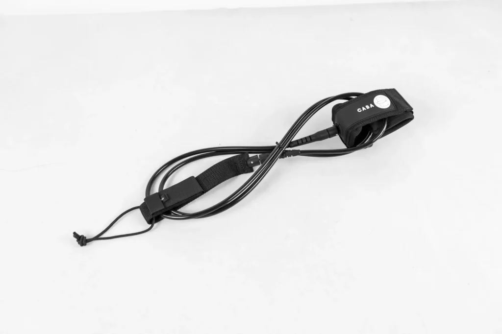 Black surfboard leash with cuff and rail saver for display