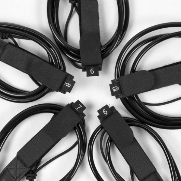 Multiple premium surfboard leashes coiled with visible length labels