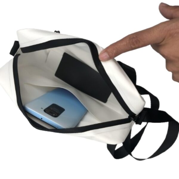 Inside view of a white waterproof mail handbag, highlighting its spacious main compartment that can hold smartphones and other small essentials, perfect for organized storage.