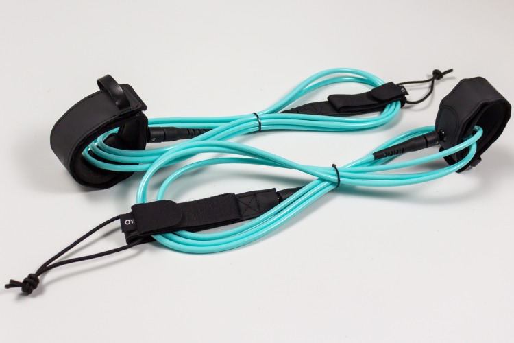 Custom premium surfboard leashes with aqua blue TPU cords and microfiber cuffs