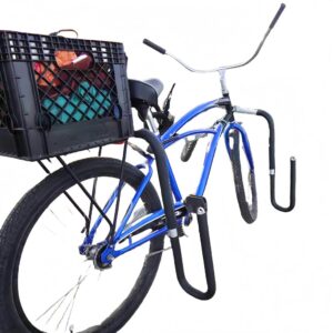 Blue cruiser bike equipped with black surfboard rack and rear cargo box near the beach