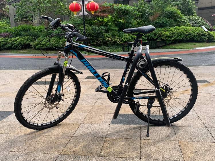 Full view of mountain bike with surfboard rack installed on seat post