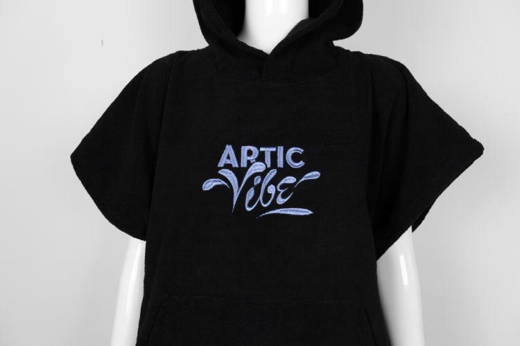 Front view of black surf poncho with "ARTIC VIBE" embroidered logo.