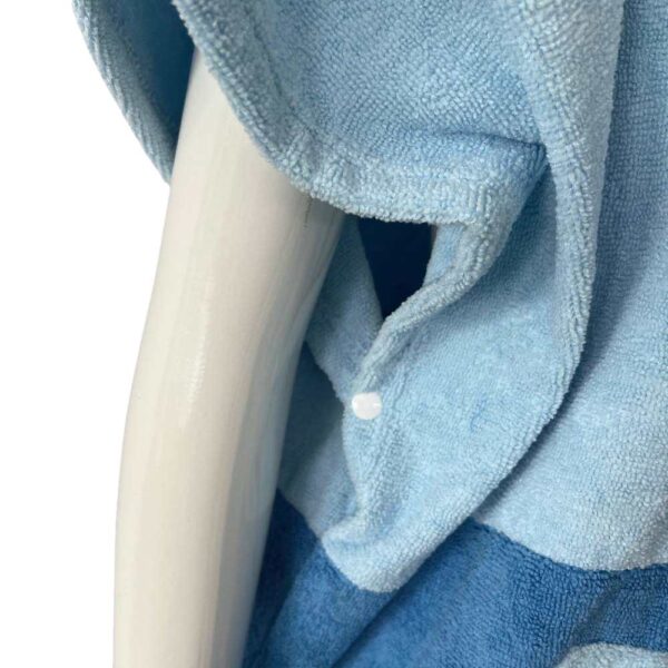 Snap button underarm design of blue surf poncho for better coverage