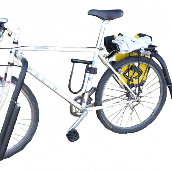 White mountain bike fitted with front and rear surfboard rack arms, parked on grass