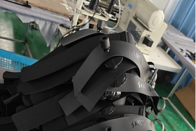 Stack of surf leash cuffs with silkscreen logos during production process