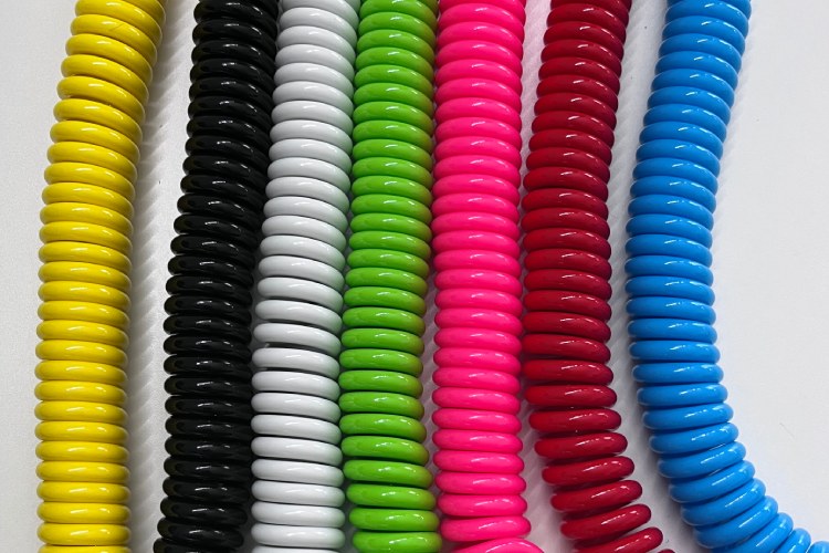 Various color options of coiled SUP leash TPU cords in row