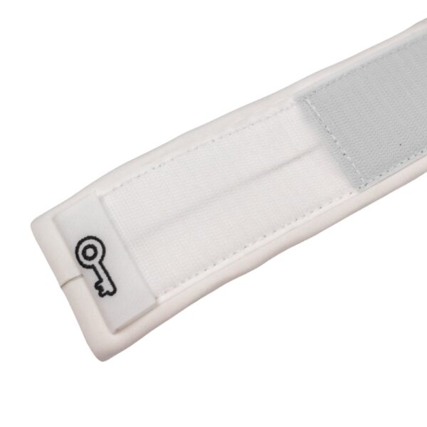 Close-up of key pocket label on white SUP leash cuff with Velcro area