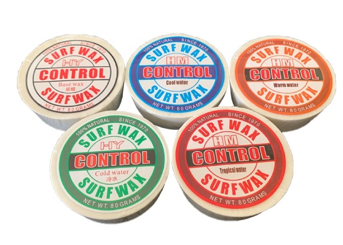 This image shows five different surf wax containers, each labeled for different water temperatures: cold water, cool water, tropical water, and warm water. They are all 80 - gram net weight and claim to be 100% natural since 1970