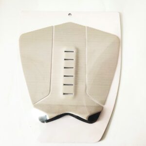 Surf pad is entirely beige. It has a symmetrical shape with evenly spaced slots, indicating its functional design for surfing.
