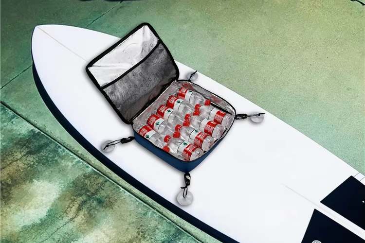 The image shows a kayak deck bag open and filled with several bottles of water. The bag is mounted on a kayak, indicating its use for storing items during a kayaking trip. 