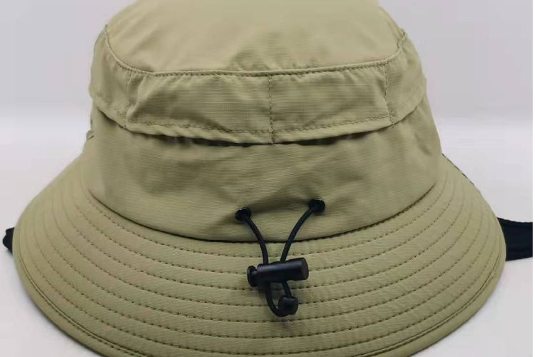 This is a khaki surf hat with a drawstring for adjusting the size, designed for outdoor water activities.